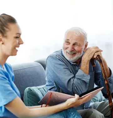senior man talking to young woman